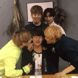 Jun and Byeongkwan kissing Chan on the cheek whilst Wow and Donghun watch gif